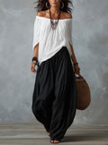 Mara • Conjunto blusa blanca hombros descubiertos y pantalón palazzo negro