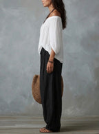 Mara • Conjunto blusa blanca hombros descubiertos y pantalón palazzo negro